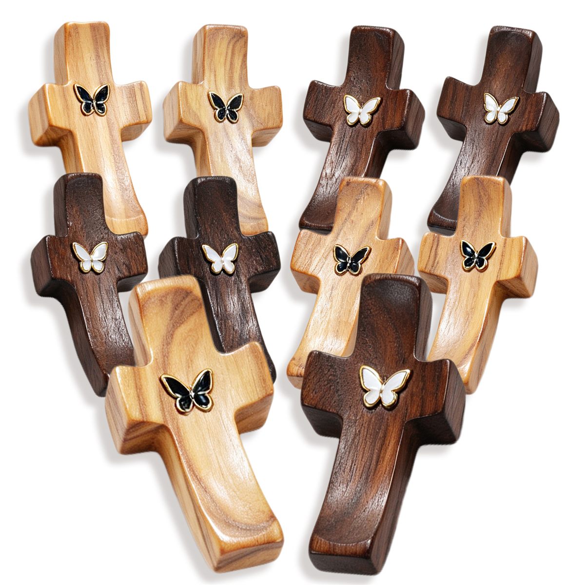 Ten wooden pocket crosses laid out, five olive wood and five black walnut with metal butterfly inlays